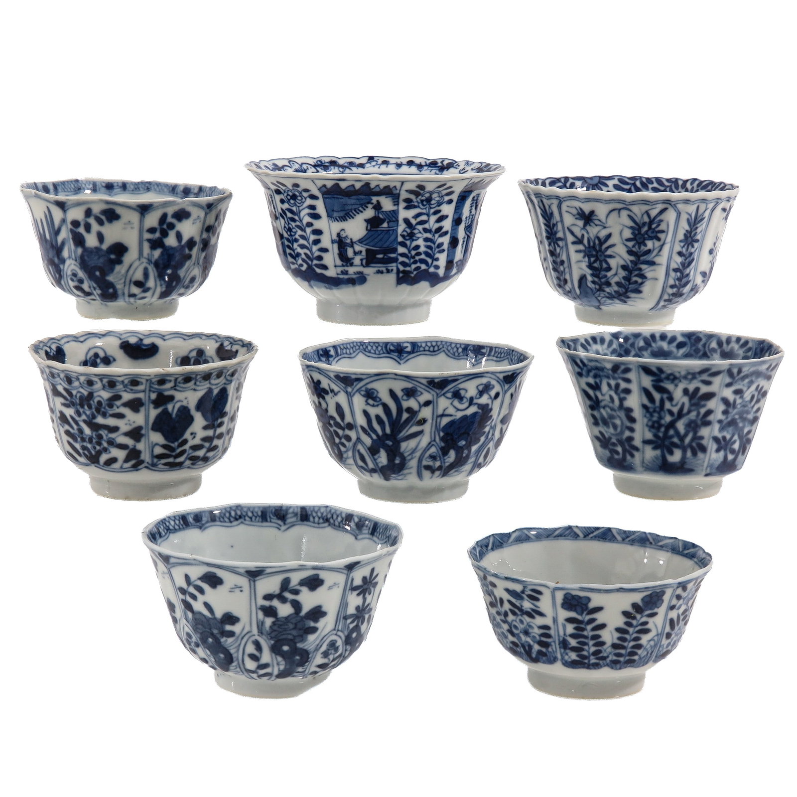 A Group of 8 Blue and White Cups: Floral decor, including 18th Century, 10 cm. in diameter, chip and hairline.