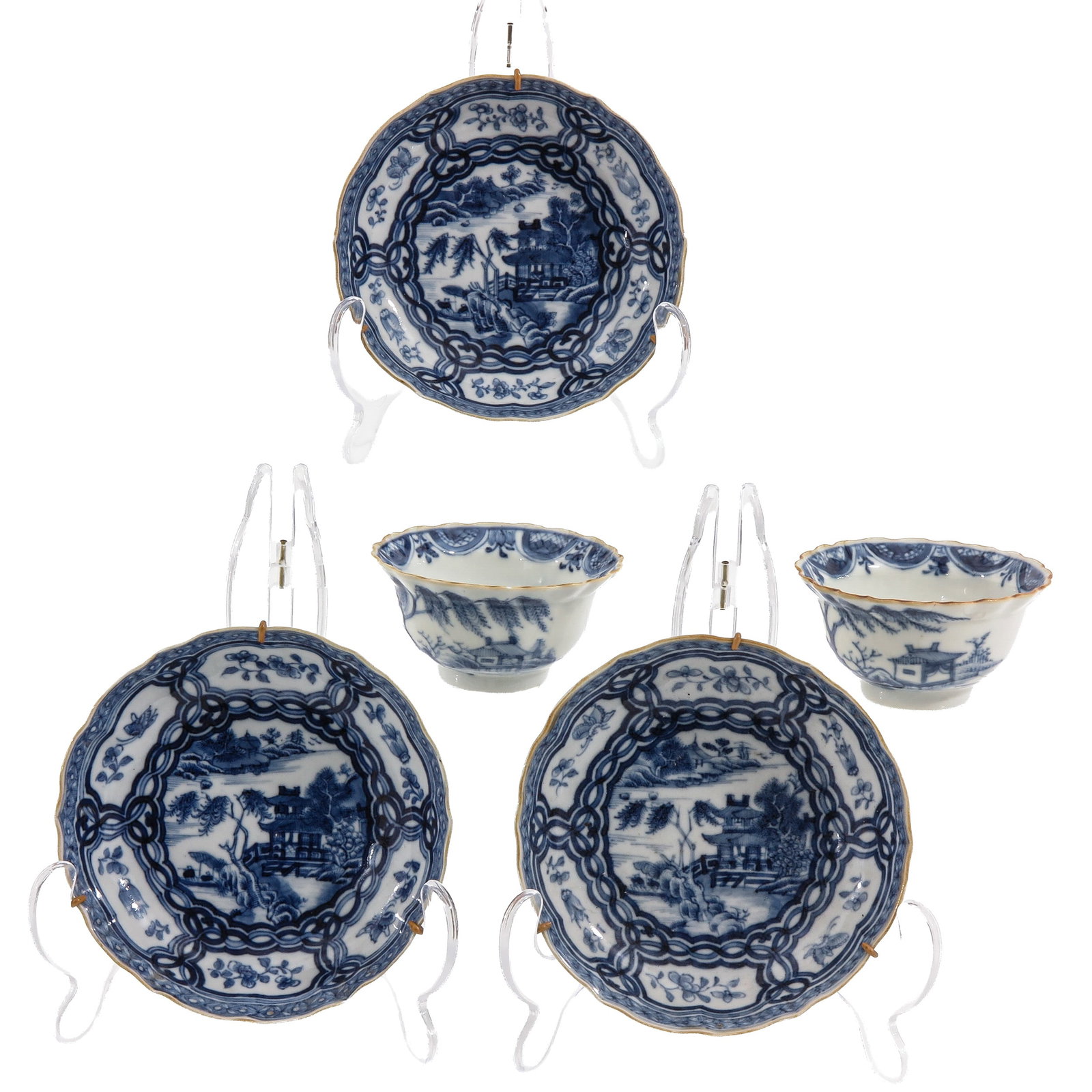 A Group of Blue and White Porcelain: Comprising of 3 saucers and 2 cups, decorated with river landscapes and pavilions, within a floral border, including 18th Century, saucers are 13 cm. in diameter.