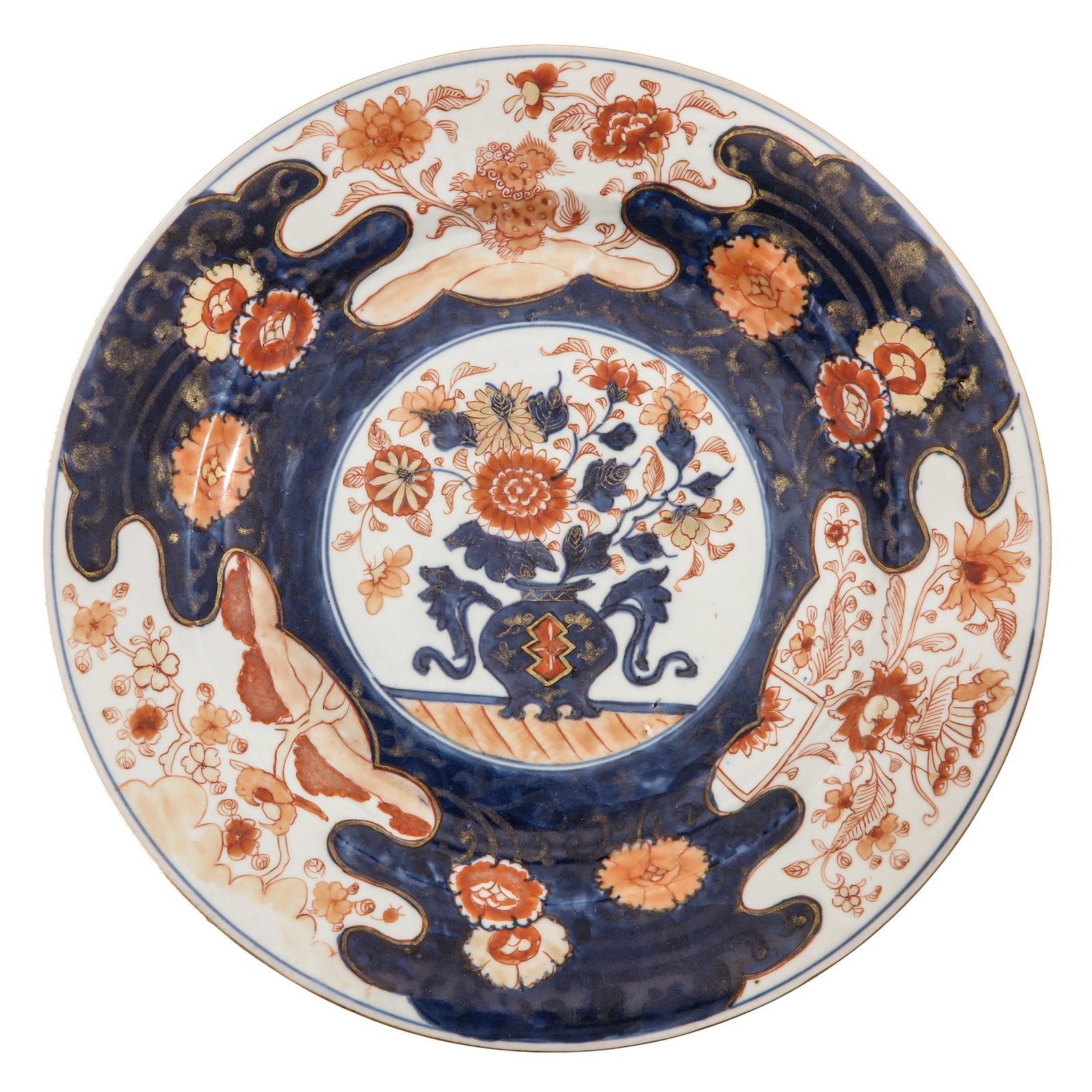 An Imari Charger: Decorated with floral motifs and a central vase of flowers, 18th Century, 29 cm. in diameter.
