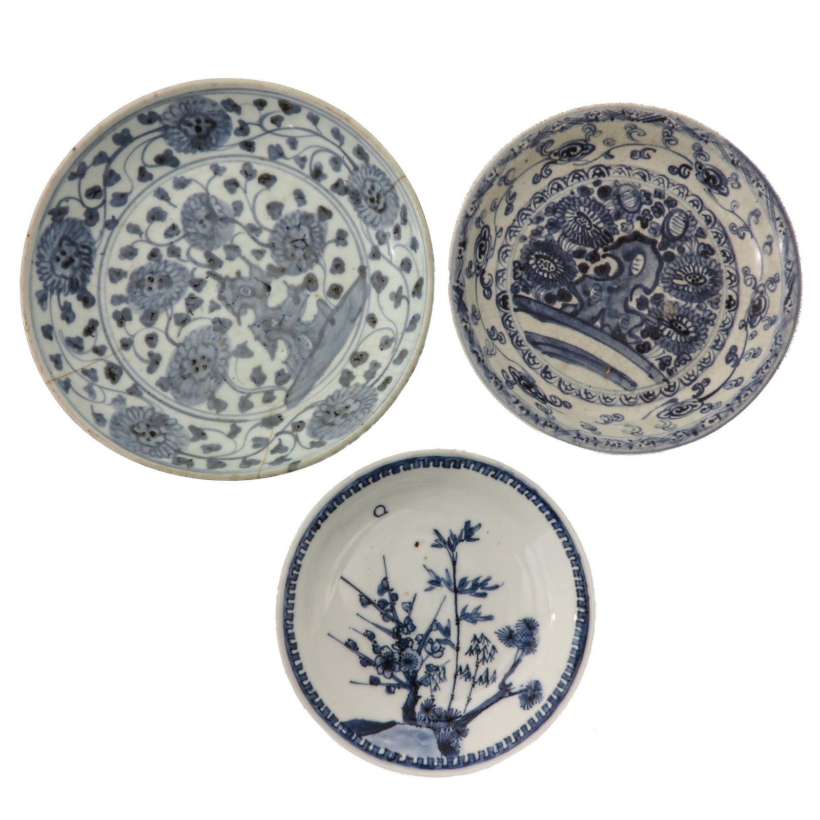 A Group of 3 Blue and White Plates: Variously decorated with floral designs, including Transitional and Ming dynasty, largest plate is 19 cm. in diameter, chip and hairline.