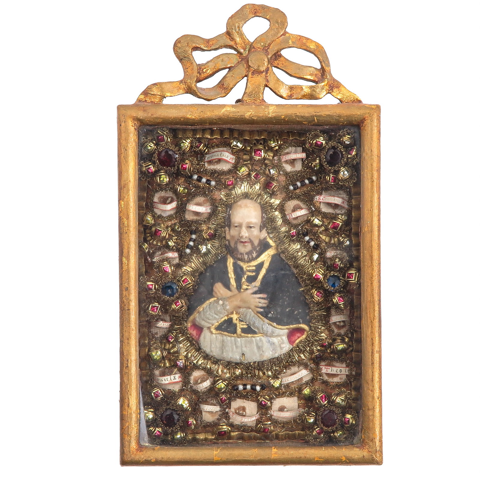 A Relic Frame: in gilt frame, richly decorated and containing various relics, including Saint Julius, Saint Thedon and Saint Ursula, virgin and martyr, patron saint of among others schoolgirls and teachers, you are