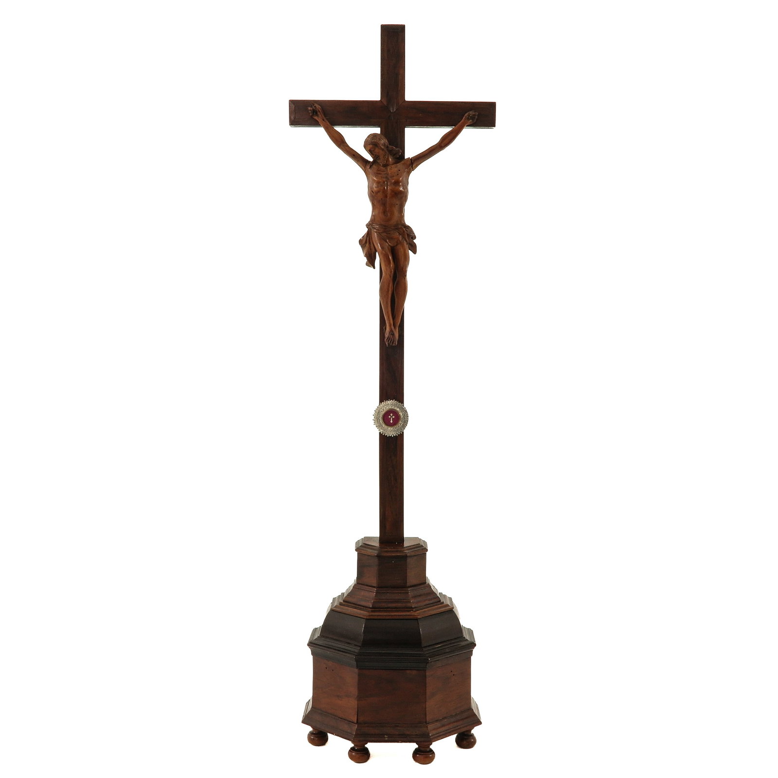 An Altar Cross: 19th century, wood, with carved Corpus Christi, provided with a theca with relic of the Holy Cross, height 70 cm.