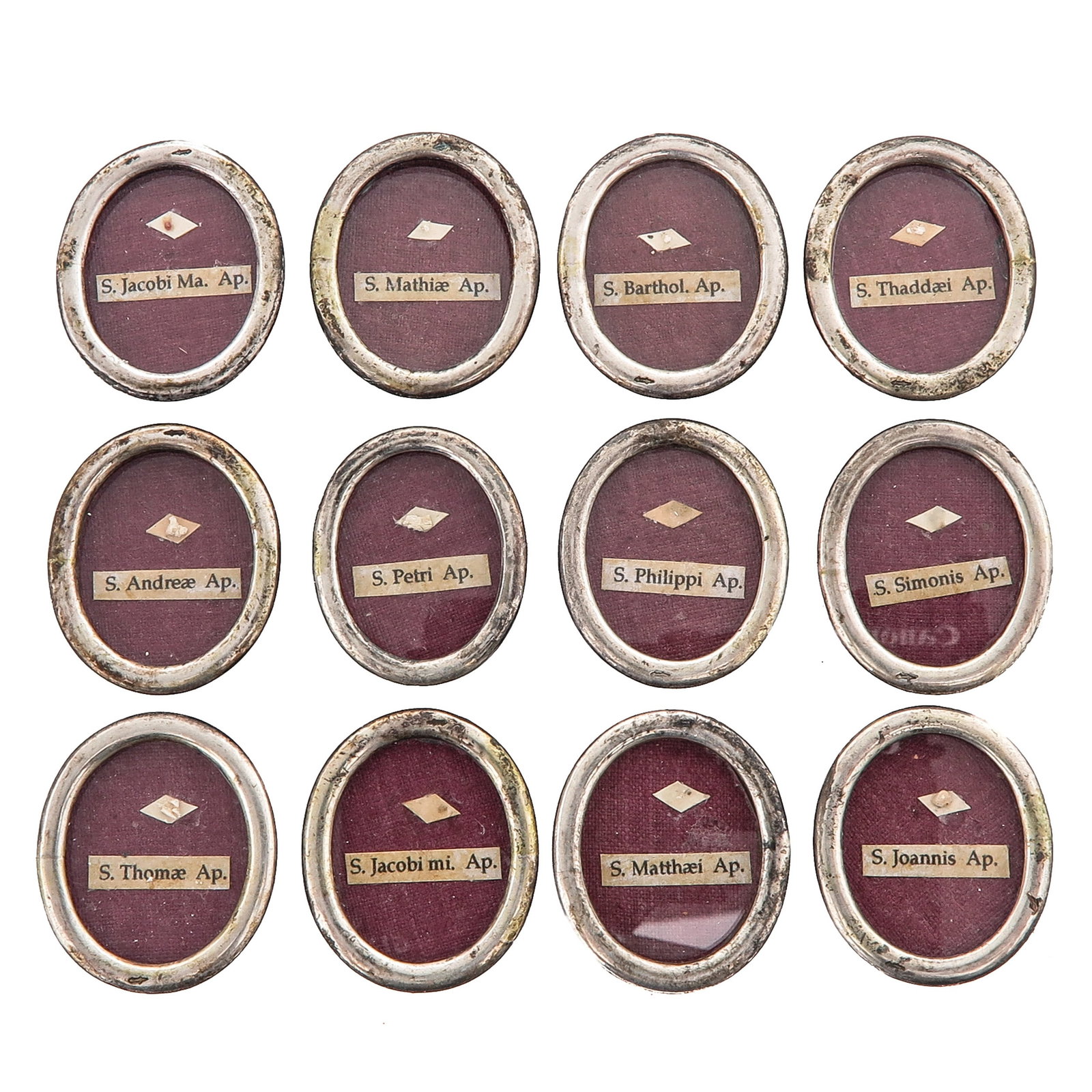 A Group of 12 Thecae: consisting of 12 thecae, each with a relic of one of the Twelve Apostles, dimensions 2 x 3 cm. each, you are purchasing the thecae, the relics are a gift