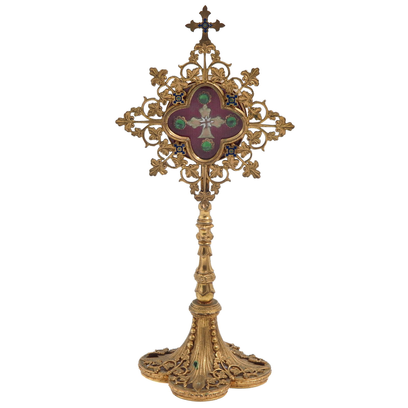 A Relic Stand: gilt bronze, richly pierced and provided with blue enamelled accents, with theca containing relic of the Holy Cross, height 23 cm.
