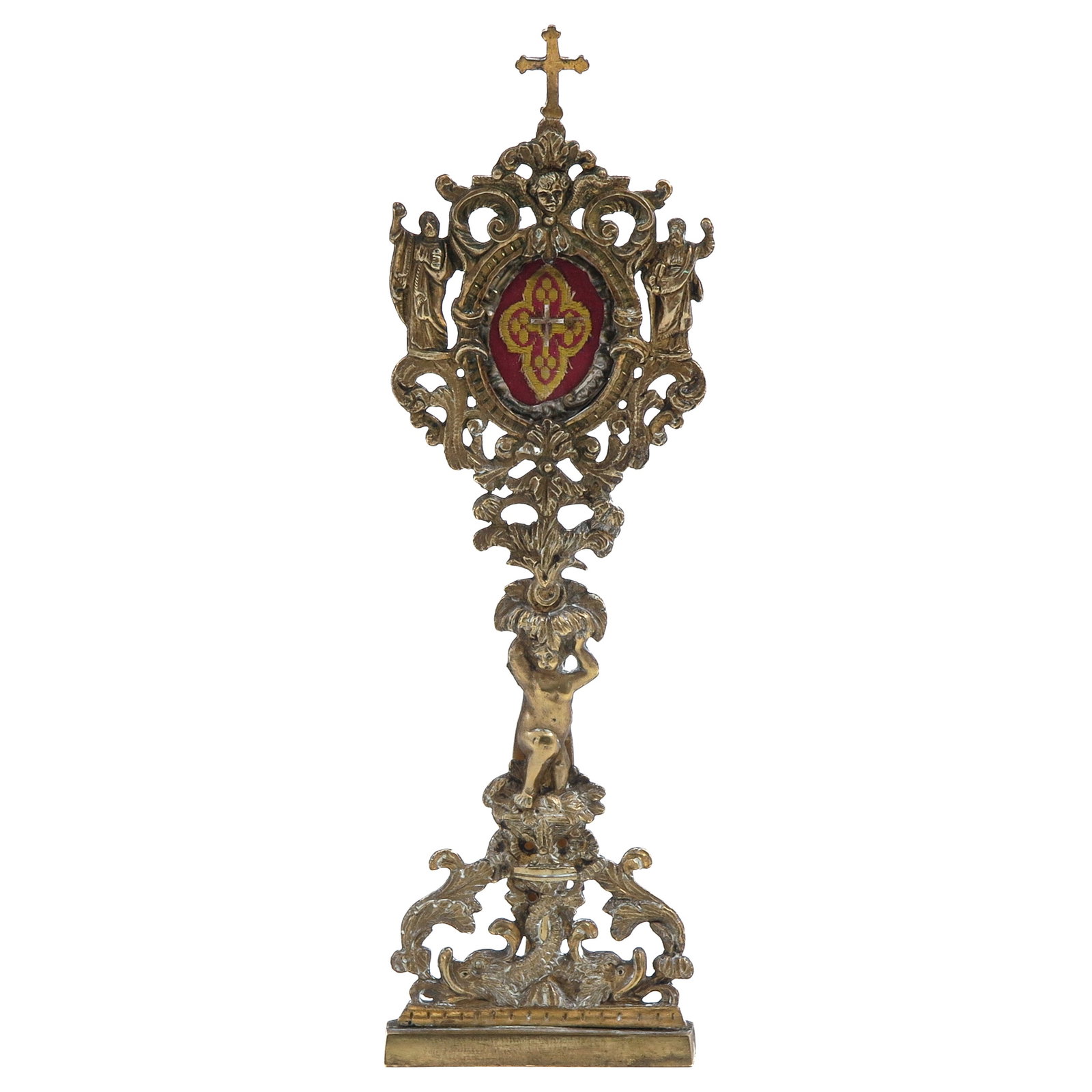 A Relic Stand: bronze, with theca containing relic of the Holy Cross, surmounted by a cross and provided with angel figures and a cherub, height 28 cm.