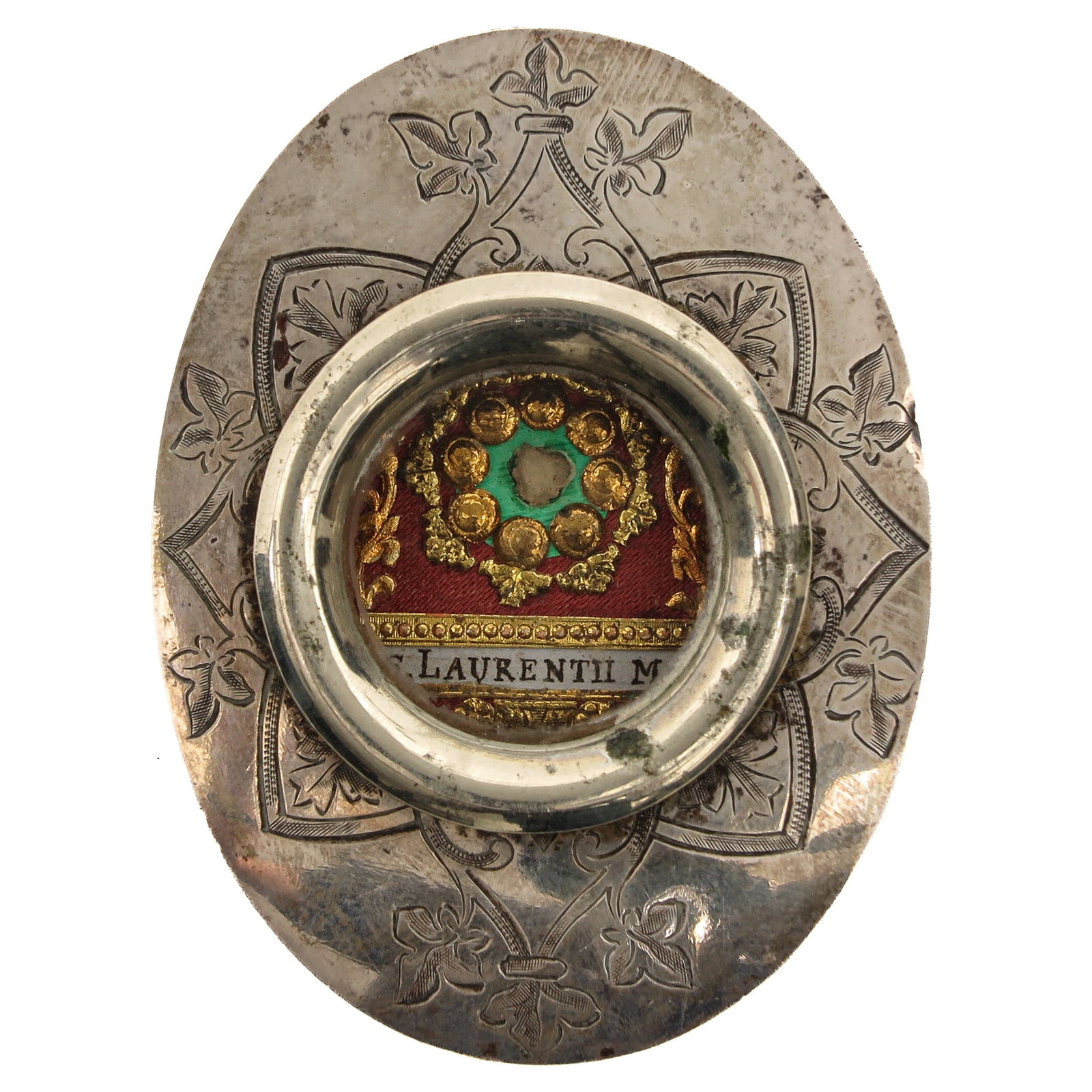 A Sealed Theca: containing relic of Saint Lawrence, deacon and martyr, patron saint of deacons, cooks, chefs, librarians and the poor, placed in an engraved oval mount, you are purchasing the theca, the relic is a gi