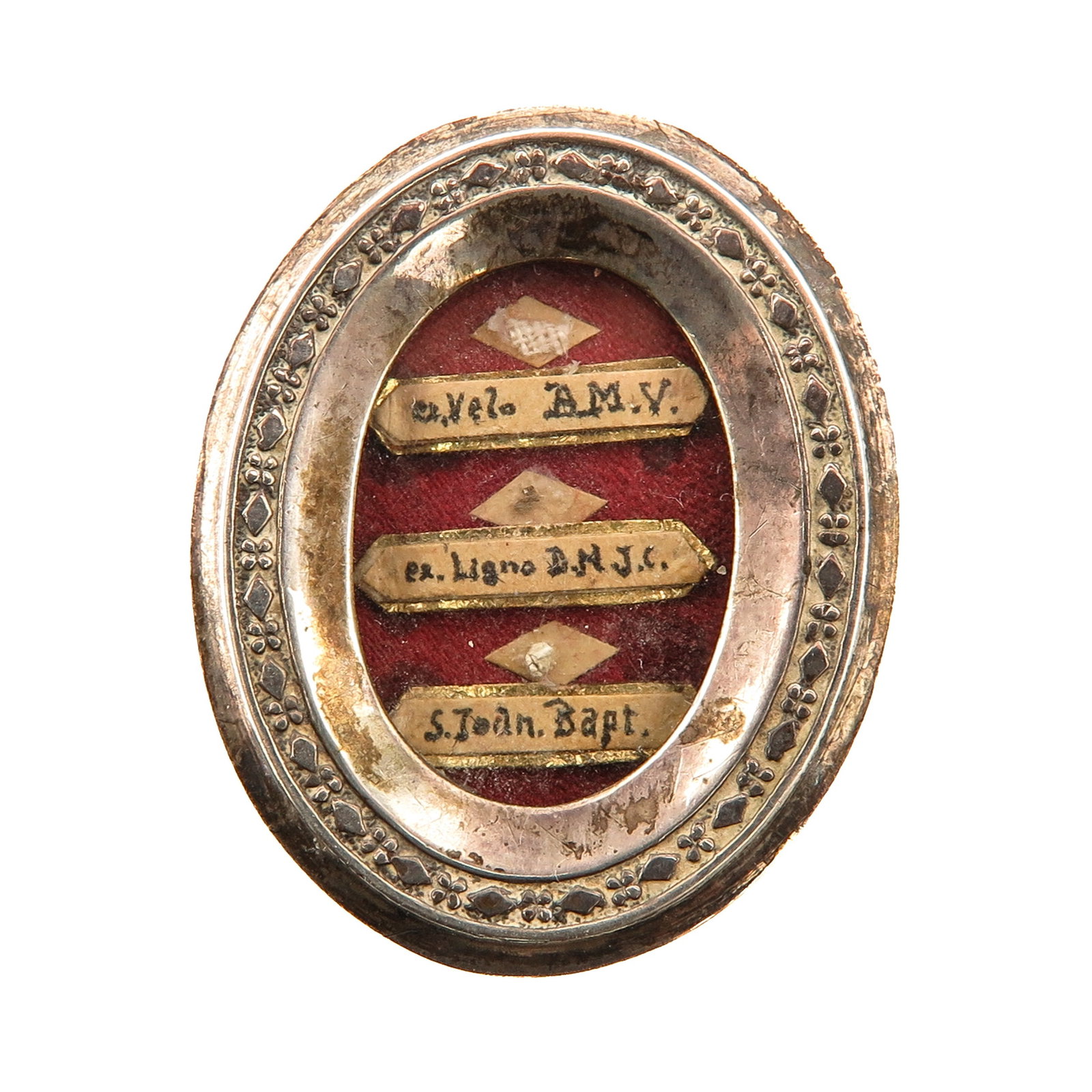 A Sealed Multi-Theca: silver, with relics ex. Velo B.M.V. (of the veil of the Blessed Virgin Mary), ex Ligno D.N.J.C. (of the wood of the Cross of Our Lord Jesus Christ) and of Saint John the Baptist, the reverse with a