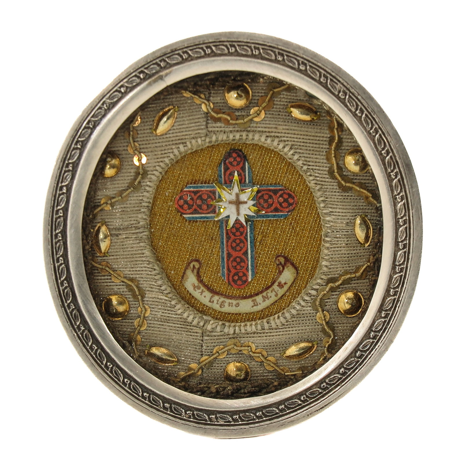 A Kiss Relic: silver, containing relic of the Holy Cross (Ex. Ligno D.N.J.C. of the wood of Our Lord Jesus Christ), executed with a central cross, dimensions 7 x 8 cm., you are purchasing the theca, the relic is a