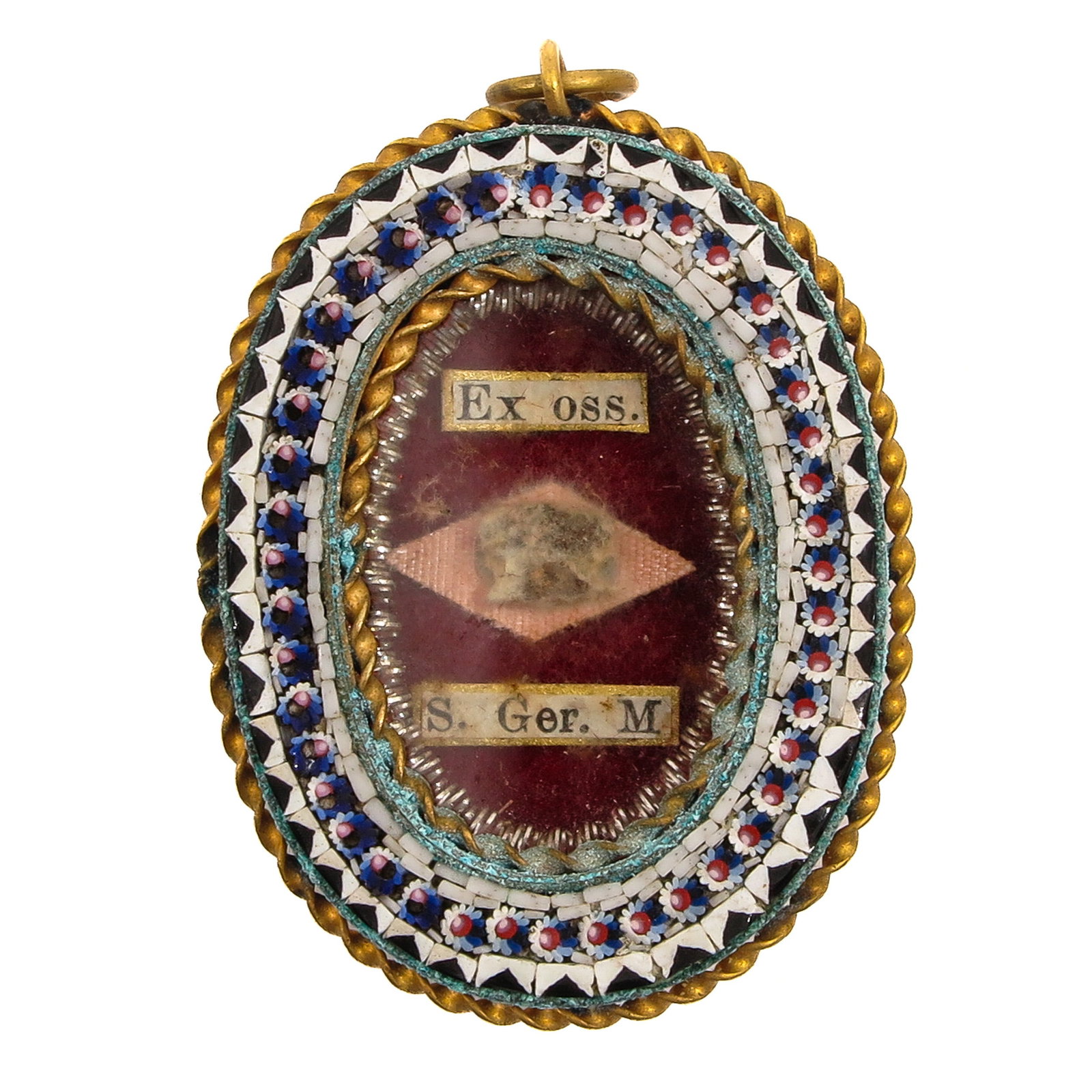 A Sealed Theca: in an oval brass mount with micromosaic, containing a relic Ex ossibus (of the bones) of Saint Ger. M., martyr, you are purchasing the theca, the relic is a gift, 3 x 4 cm.