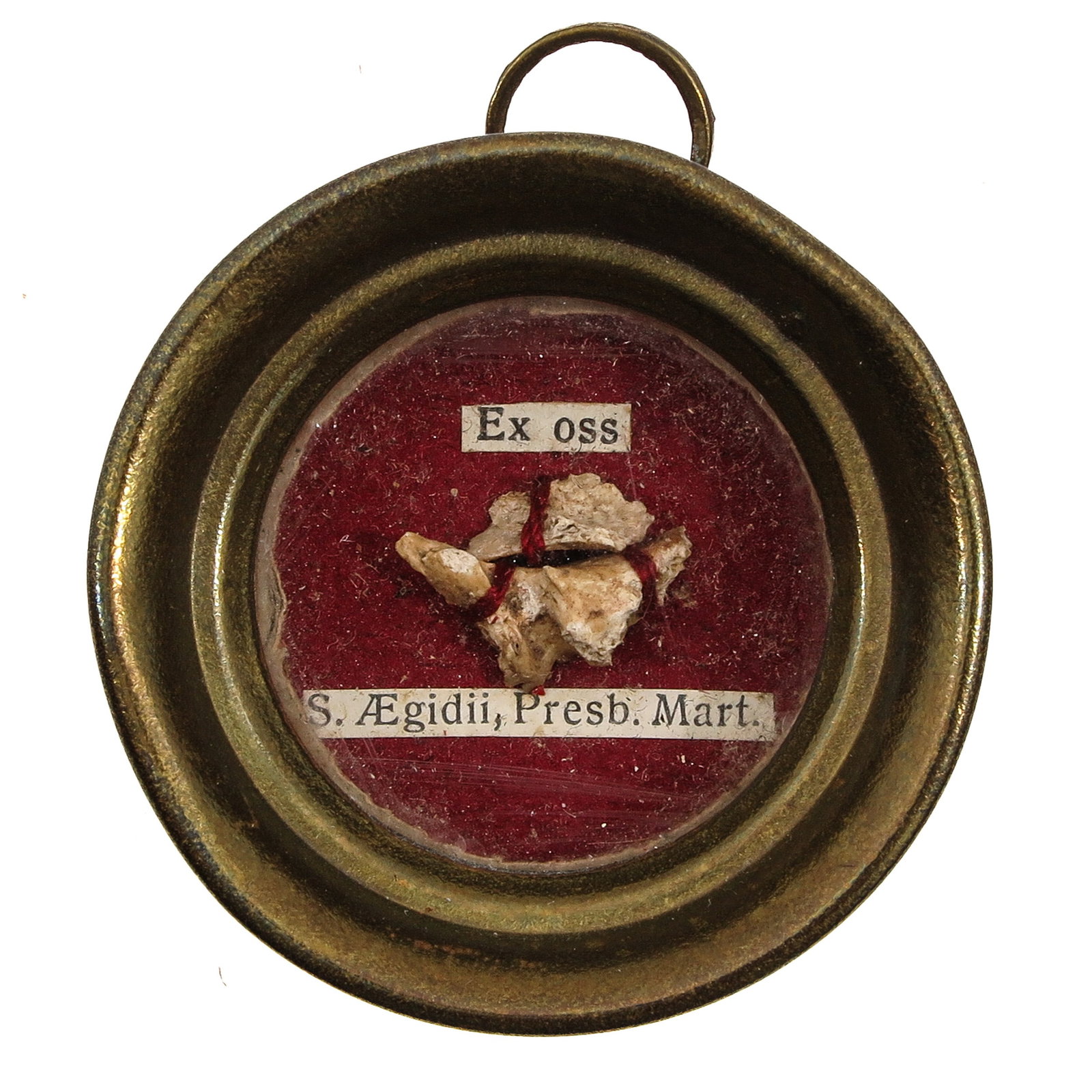 A Sealed Theca: of brass, with relic (ex ossibus) of Aegidius, priest and martyr, venerated as intercessor in illness, poverty and physical need, you are purchasing the theca, the relic is a gift, diameter 5 cm.