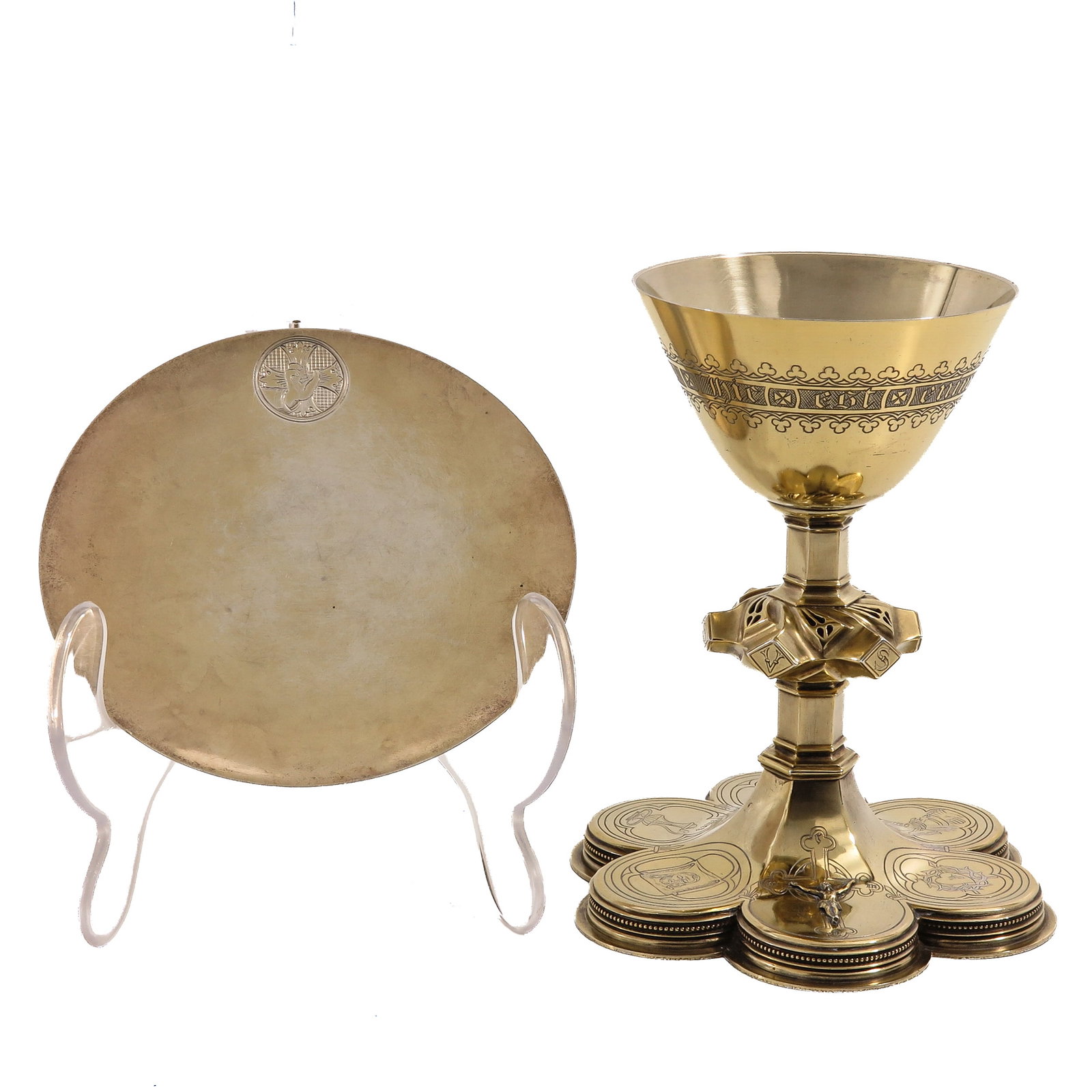 A Chalice: with paten, the paten hallmarked 800/1000, Neo-Gothic, richly gilt, with foot provided with engraved medallions and an applied crucifix, with depiction of the Holy Spirit as a dove on the paten,