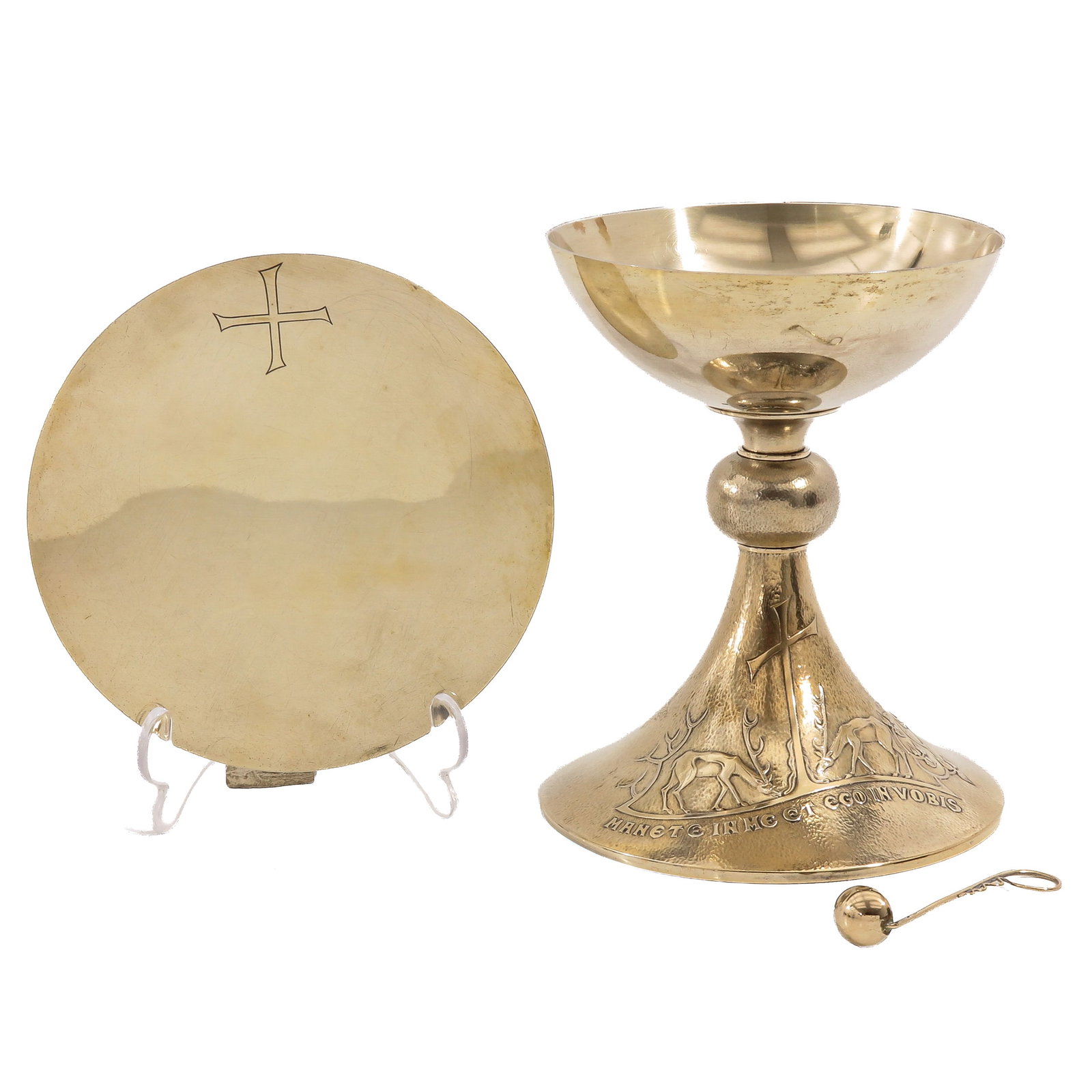 A Chalice: with paten and spoon, hallmarked 835/1000, with a depiction of a cross flanked by two deer and the inscription Manete in me et ego in vobis, engraved cross on the paten, height 19 cm.