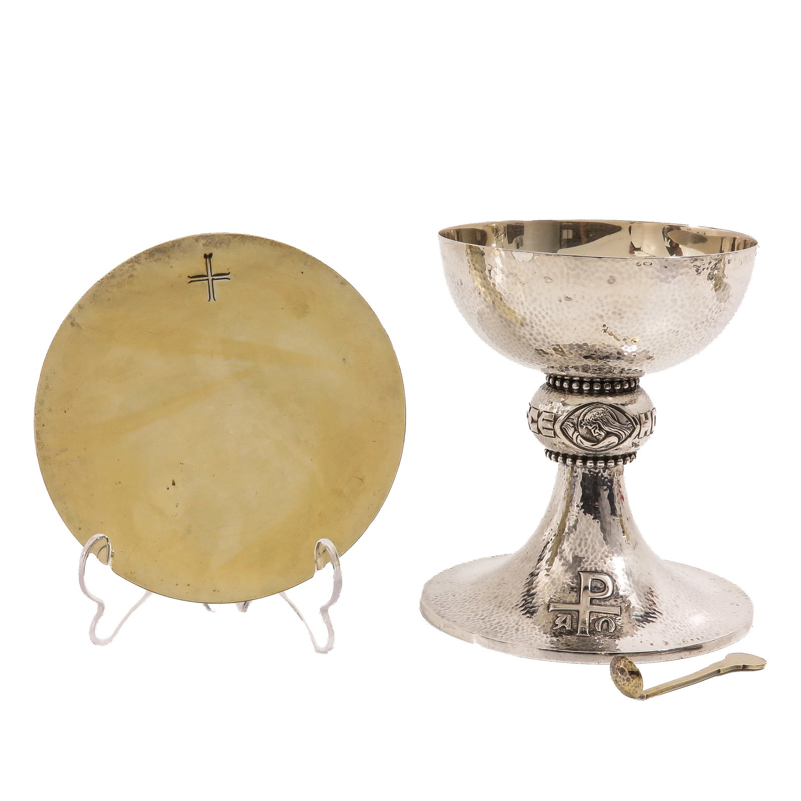 A Chalice: with paten and spoon, the paten hallmarked 2nd grade silver, with hammered cuppa and foot, node with a medallion of Christ with the crown of thorns, Chi-Rho on the foot and an engraved cross on the