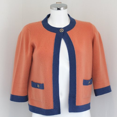 Chanel Cashmere Ladies Sweater: Peach and blue in color with Chanel logo buttons on pockets and top button closure. Size 40