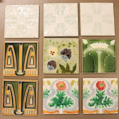 Assortment of 9 Art Nouveau Glazed Ceramic Tiles: including Minton and England marked tiles, 15 x 15 cm