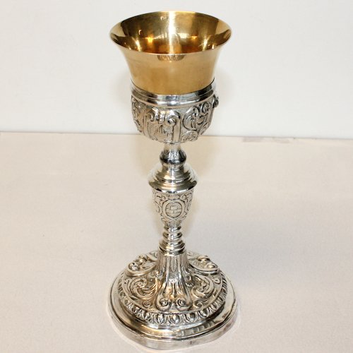 19th Century French Silver Chalice: Very highly decorated with praying hands and other religious symbols surrounding the chalice, fine detail to silver, 27 cm tall