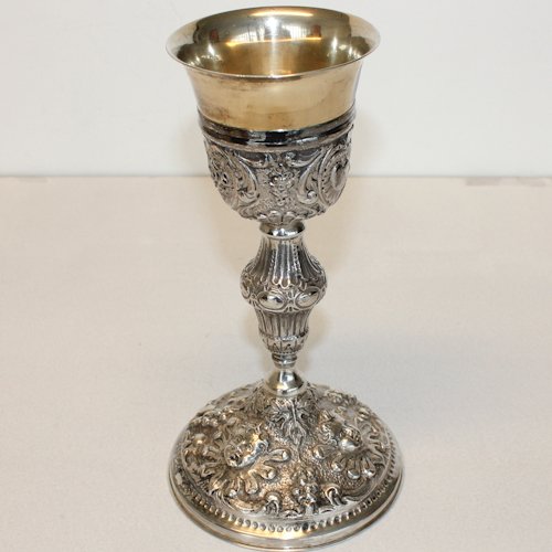 19th Century French Silver Chalice: Highly decorated chalice surrounded with angel faces on base and religious symbols surrounding base of cup
