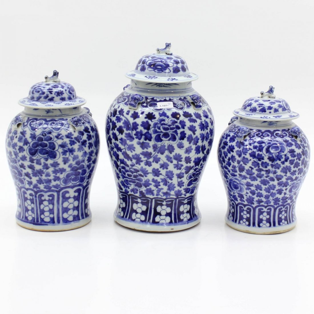 Lot of 3 China Porcelain Lidded Baluster Vases: Blue and white floral decor with lids depicting foo dogs, tallest vase is 46 cm.