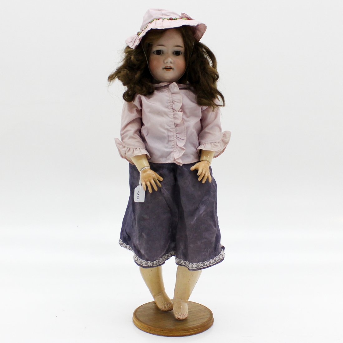Armand Marseille 390: Porcelain doll with painted lashes and partial real lashes remain, sleep eyes, 4 teeth, link body of wood, movable wrists, marked 390 D.R.G.M. A.10.M., 70 cm tall.
