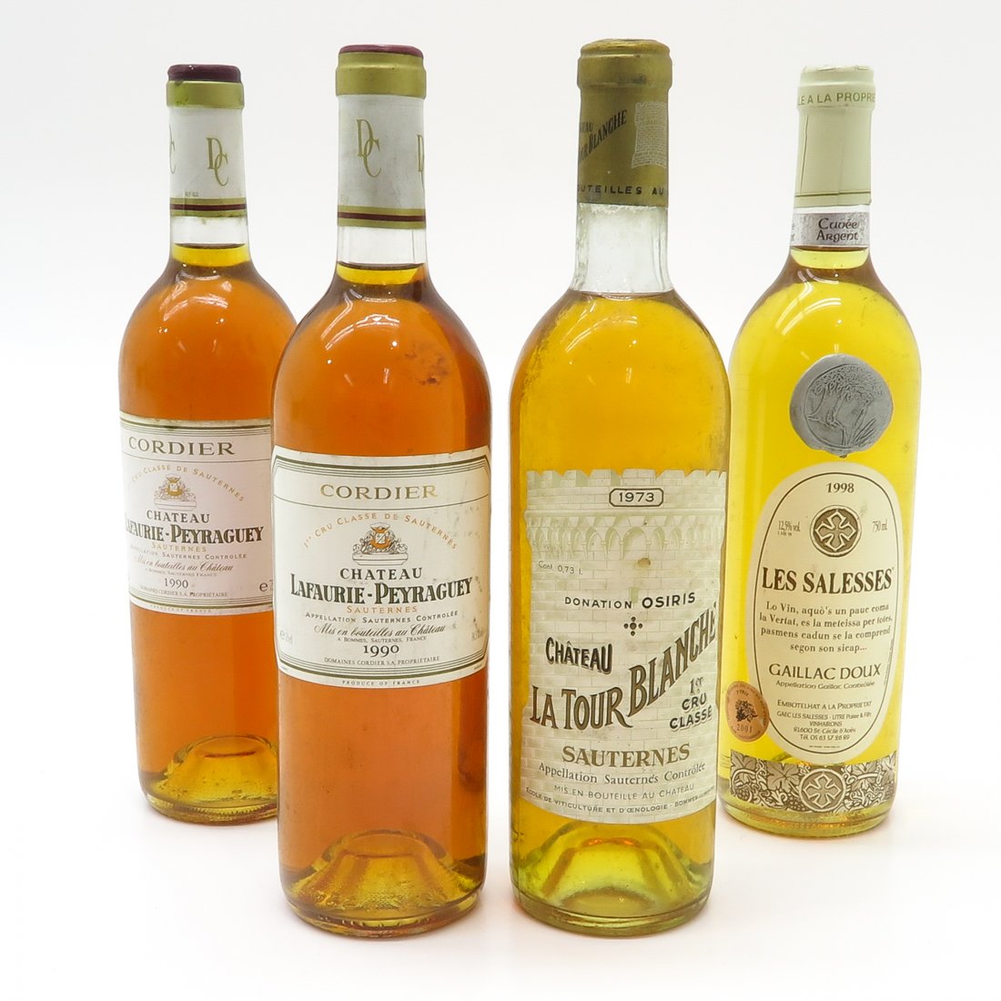 Diverse Lot of Vintage Wine: Including 2 bottles of Chateau Lafautie Peyraguey 1990, 1 bottle of Les Salesses Gailan 1998, and 1 bottle of Chateau La Tour Blanche Sauternes 1973.