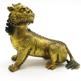 Chinese Gilt Bronze Lion Sculpture: Marked with 6 characters on the belly, 16 x 14 x 7 cm.