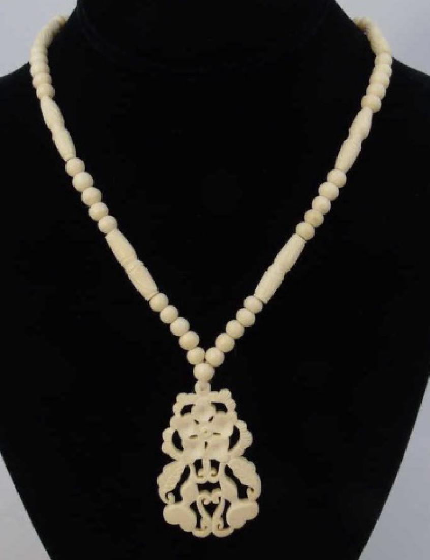 Antique Chinese Carved Bone Necklace & Pendant: Antique Chinese Carved Bone Necklace & Pendant. Having carved bone, likely ox or bovine, beads and clasp with a large pendant of flowers and gourds. Necklace measures 24 inches in length, pendant meas