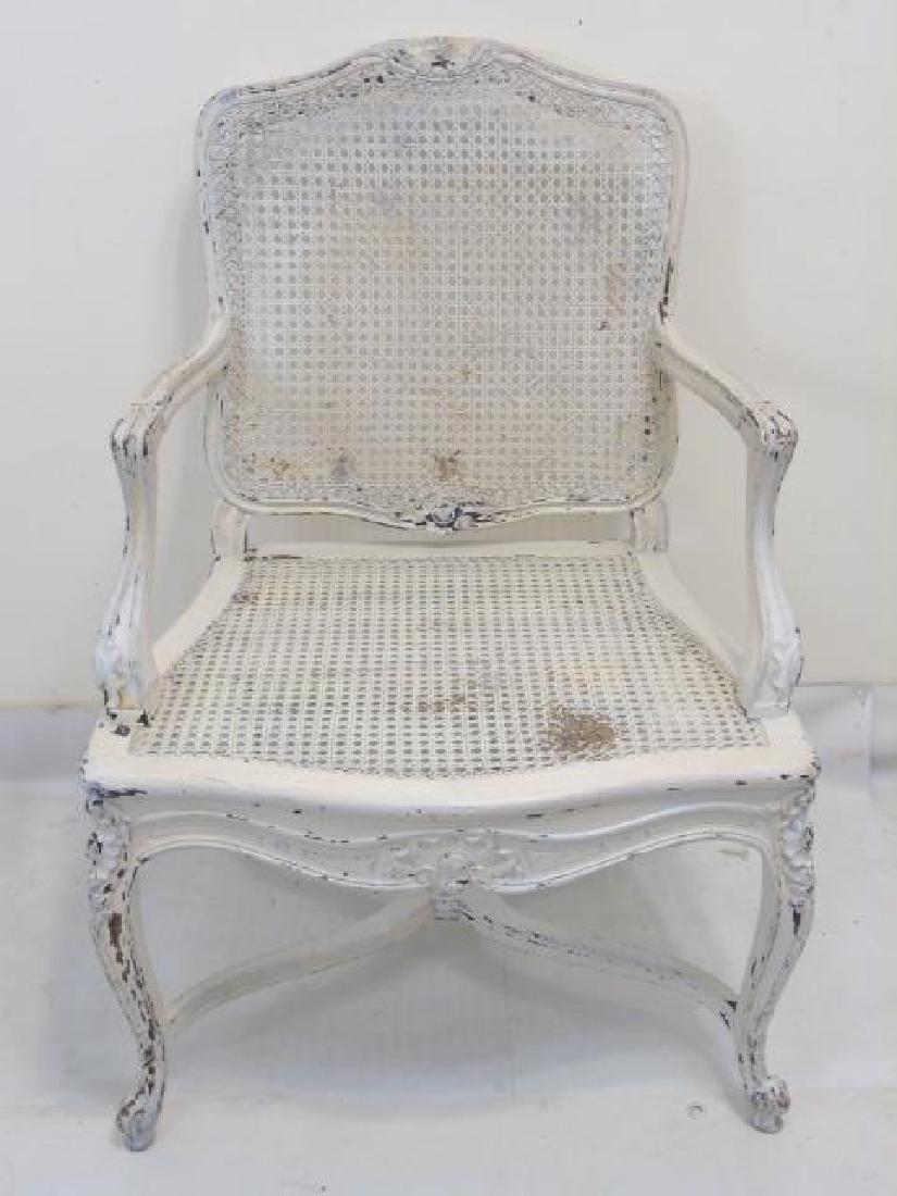 Antique Carved French Rococo Style Caned Armchair: Antique Carved French Rococo Style Caned Armchair. Having a distressed painted finish. Measures 36.5 x 24 x 20 inches.