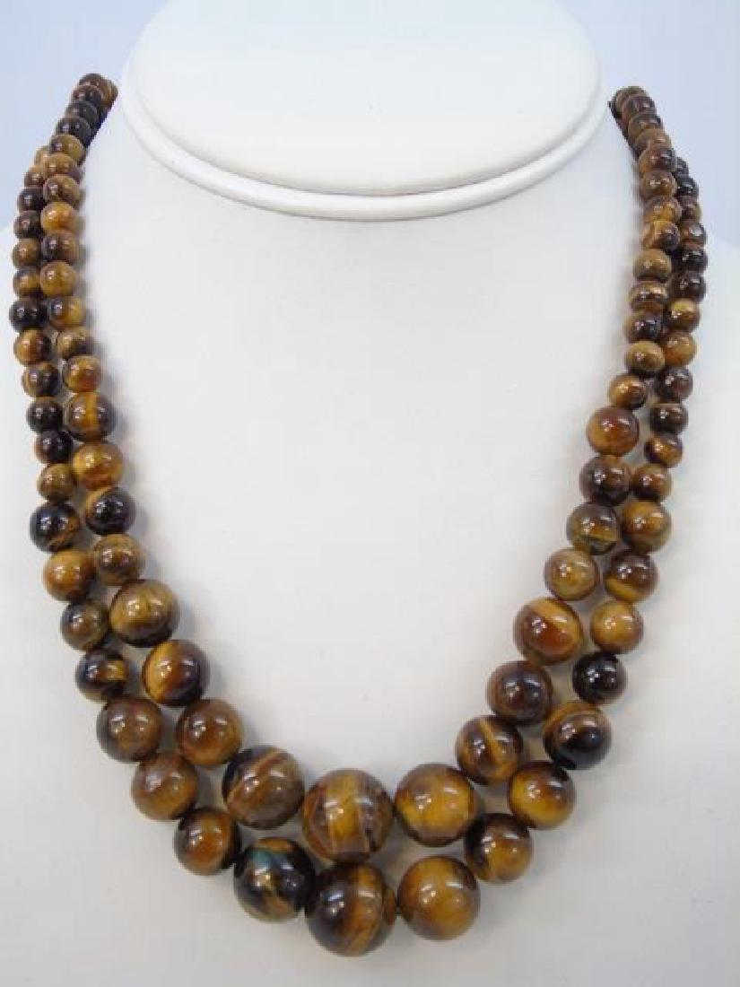 Pair Carved Tigers Eye Graduated Bead Necklaces: Pair Carved Tigers Eye Graduated Bead Necklaces. Each set with silver tone lobster clasp. Each measures 18 inches in length.