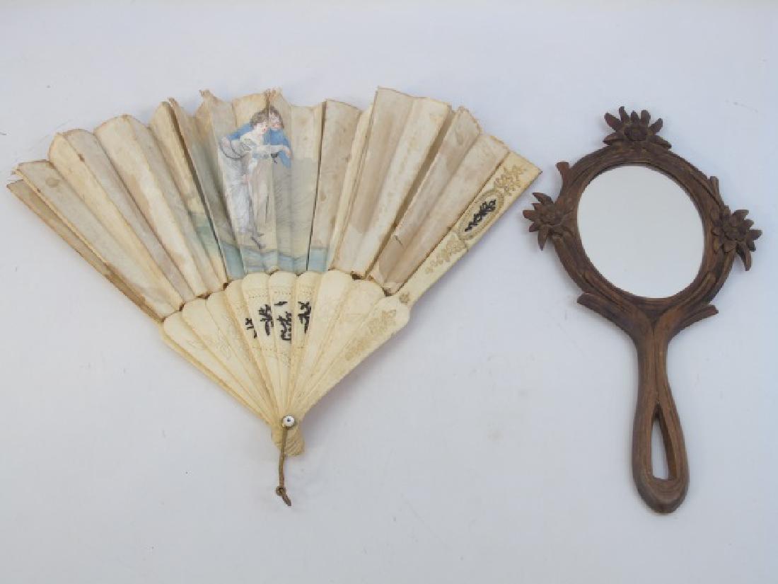 2 Antique Ladies Vanity or Boudoir Items Mirror: 2 Antique Ladies Vanity or Boudoir Items, including a Black Forest style Carved Mirror trimmed with Edelweiss and an antique hand painted silk and bone fan. Mirror measures 12.5 inches high.