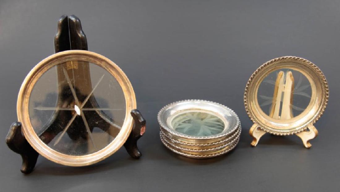 Six Wallace Sterling Silver & Glass Wine Coasters: Six Wallace Sterling Silver & Glass Wine Coasters. Each with cut glass / etched glass design. Larger marked for Wallace, all marked for sterling. Largest measures 5 inches in diameter.