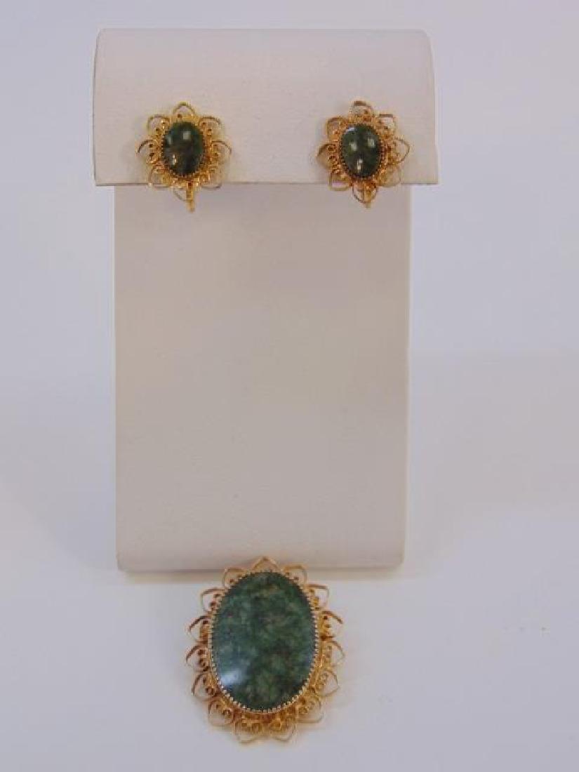 Estate Earring & Brooch Jade & Gold Filled Suite: Estate Earring & Brooch Jade & Gold Filled or Plated Suite. Cabochon stones appear to be Jade or Moss Agate. Brooch / necklace pendant and pair of earrings. Pendant measures 1.75 inches in length.