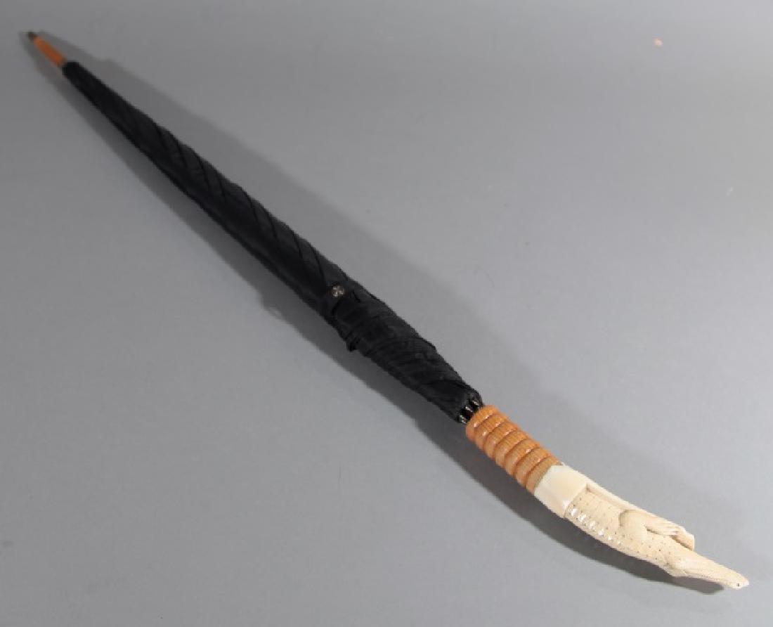 Antique Umbrella with Carved Bone Alligator Handle: Antique Umbrella with Finely Carved, highly detailed Bone Alligator Handle. Measures 37 inches long in total.