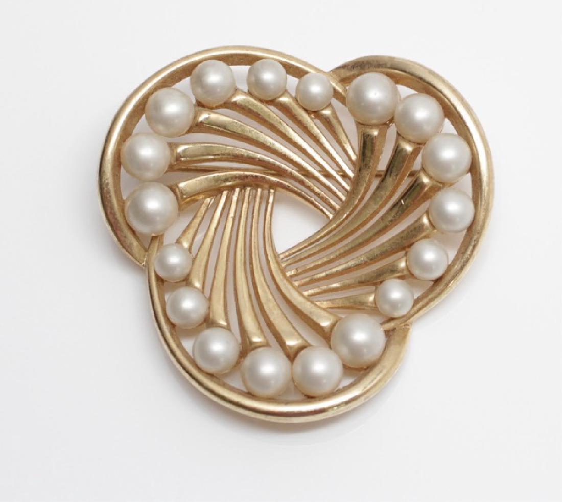1960's Trifari Pearl & Gold Swirl Trefoil Brooch: 1960's Trifari Pearl and Gold Trefoil Brooch. Vintage elegance in pearl and gold-tone swirls. Substantial brooch weighs 30 grams and measures 2 inches in diameter.