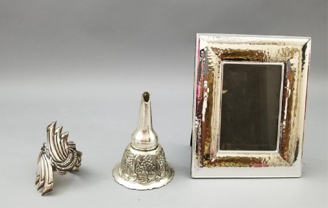 Trio of Silver Items, Including Sterling Bracelet: Trio of Silver Items, Including Sterling hinged cuff Bracelet, wine decanter funnel, and a frame for a 4 x 6 inch photograph. Outer frame measures 7.5 x 9 inches.