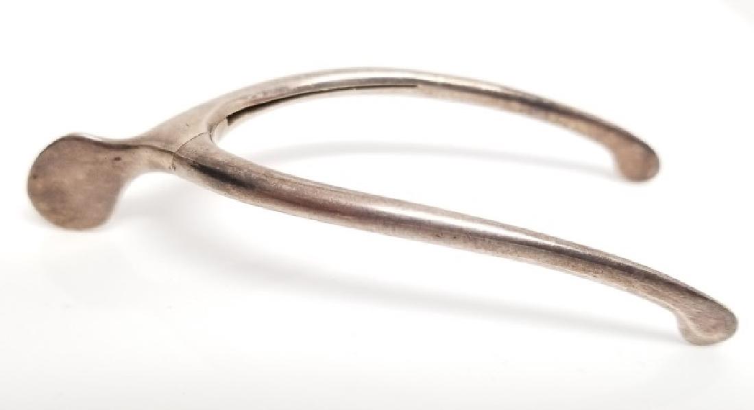 Antique Figural Sterling Silver Wish Bone Tongs: Antique Figural Sterling Silver Wish Bone Sugar / Serving Tongs. Hallmarked. Measures 3.25 inches in length.