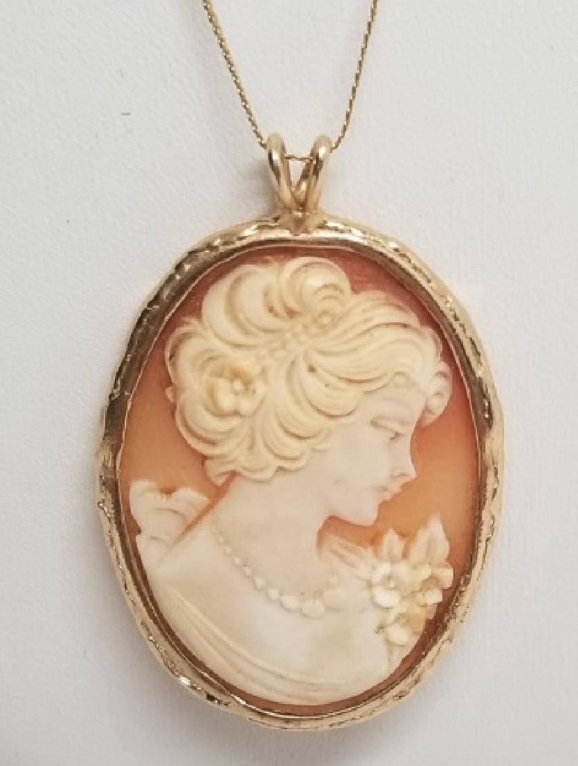 Estate Carved Cameo Pendant on 14k Gold Necklace: Estate Carved Cameo Pendant on 14k Gold Necklace. Carved natural shell portrait cameo. Chain marked 585 and Italy. Chain measures nearly 20 inches in length. Total weight approximately 12.5 grams incl