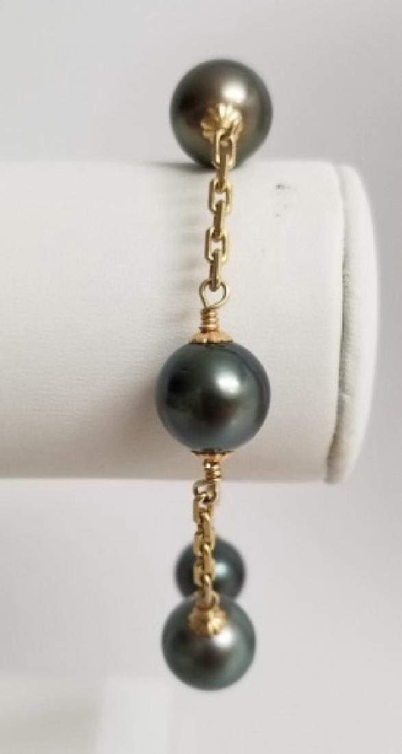 14kt Yellow Gold & Tahitian Round Pearl Bracelet: 14kt Yellow Gold & Tahitian Round Pearl Bracelet. Hallmarked. Set with five round Tahitian pearls approximately 11mm. Measures 7.75inches in length. Weighs approximately 16.3 grams inclusive.