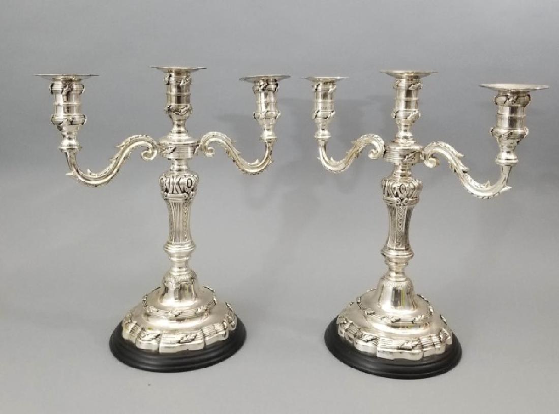 Pair Silver Plate 3 Arm Classic Candelabra: Pair Silver 3 Arm Classic Candelabra on plastic bases. Both measure 17 inches tall.