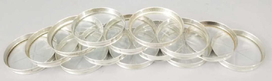 Set of 14 Hammered Sterling Silver Border Coasters: Set of 14 Hammered Sterling Silver Border Coasters. With cut glass star motif base. Hallmarked. Each measures 3.25 inches in diameter.