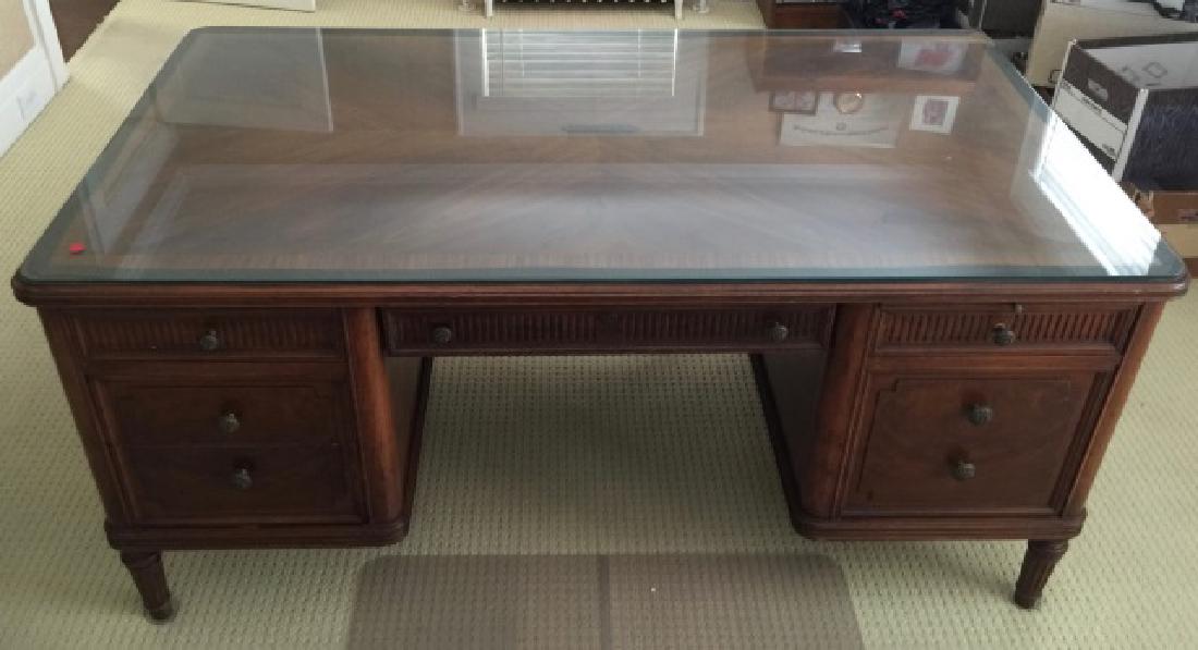 French Style Carved & Burl Wood Executive's Desk: French Style Carved & Burl Wood Executive's Desk w Custom Cut Glass Top. Burl and banded wood detail, carved legs. Measures 31 x 64 x 30 inches.