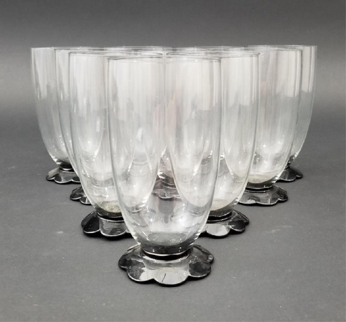 Unusual Set 10 Clear & Black Glasses w Flower Foot: Unusual Set of Clear & Black Glasses w Flower Foot. Set of 9 in perfect condition and 1 with a small chip to the underside of the foot. Measuring 5.5 inches.