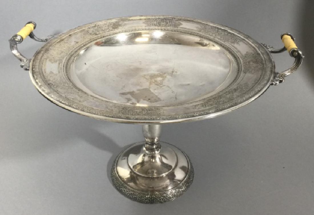 Large Antique Silver Plate Compote w Bone Handles: Large Antique Silver Plate Pedestal Compote w Bone Handles. Measures 9 inches tall with a diameter of 13 inches. Having ornate Floral and Art Nouveau details, a tall pedestal foot, and 2 hand-carved b