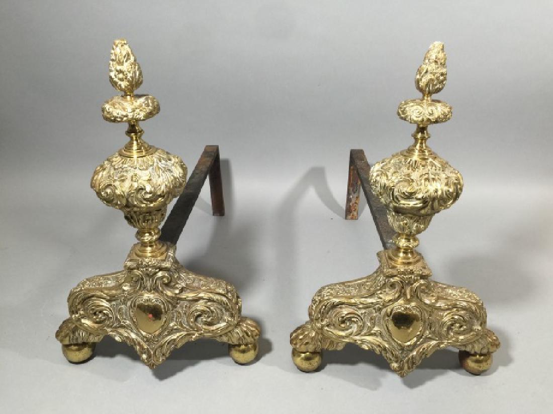 Pair of Ornate Brass Andirons: Pair of Ornate Brass Andirons. Measure 18 x 11 x 19 inches.