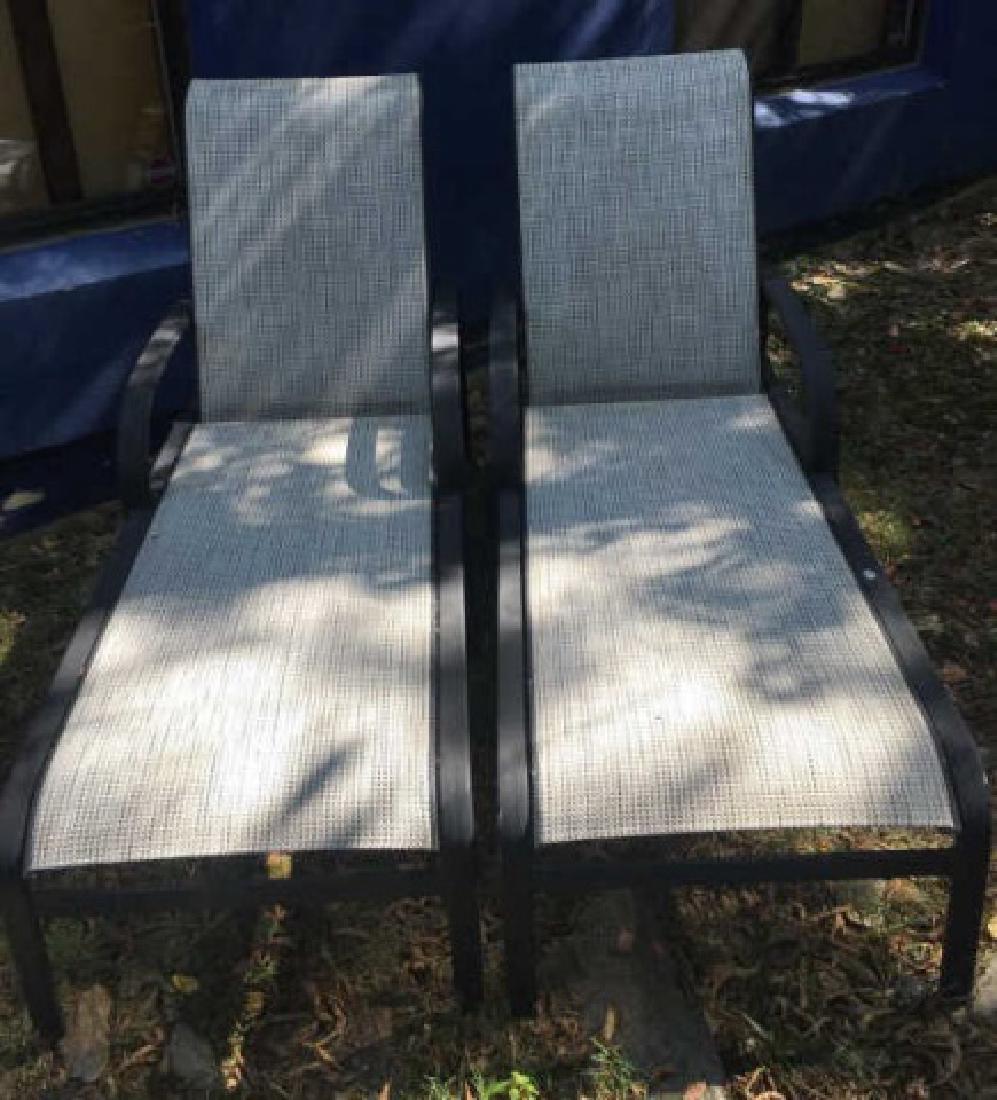 Pair Contemporary Mesh Chaises Lounges: Pair Contemporary Mesh Chaises Lounges in Style of Brown Jordan, with black painted metal and cream/black mesh seats. Laying flat, each lounge measures 78 x 26 x 23 inches. Unmarked.