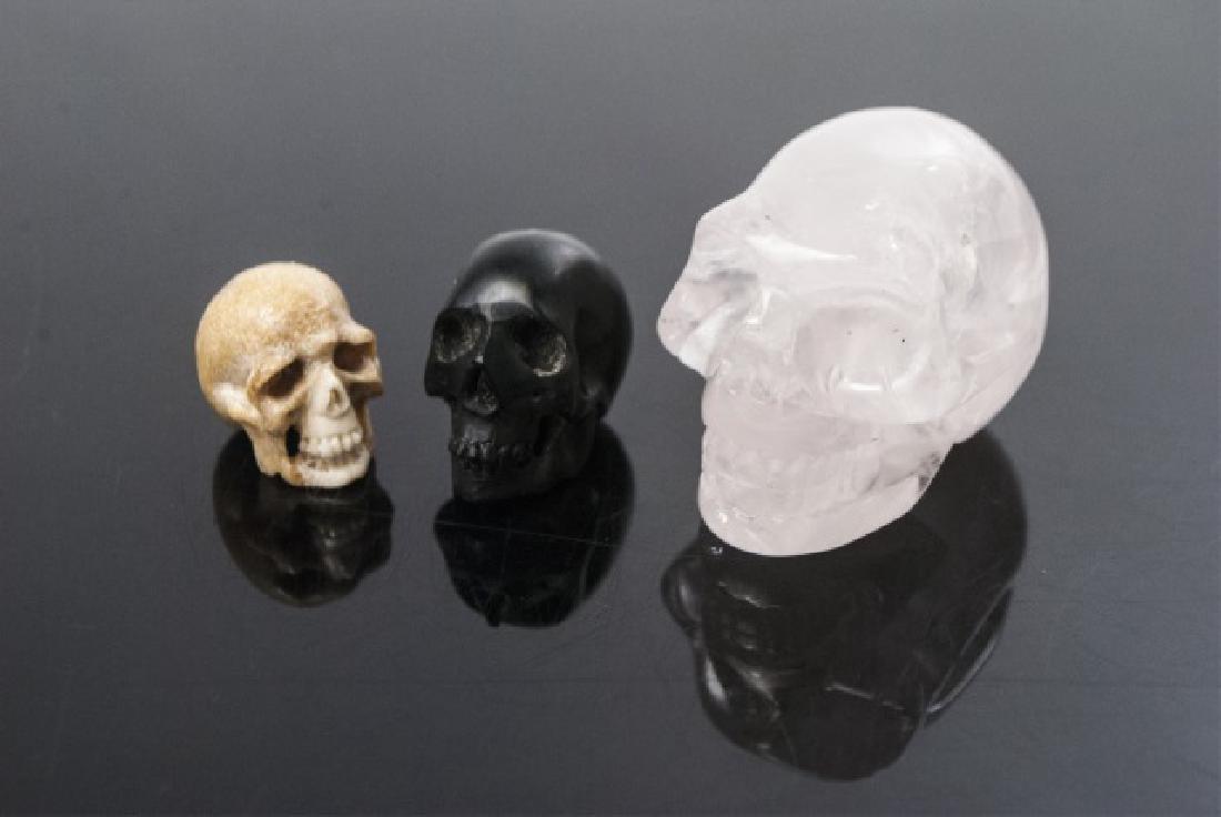 Rose Quartz, Bone & Ebony Wood Skulls / Pendants: Hand Carved Rose Quartz, Bone & Ebony Tone Wood Skulls. Miniature statues or great for jewelry making. Rose quartz skull measures 1.25 inches in length. Some with holes to be used as pendants