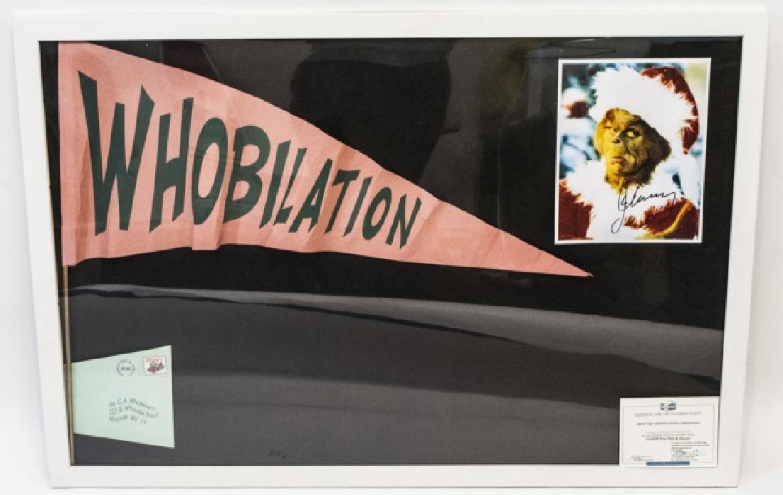 Authenticated Banner - "The Grinch" Movie, & Photo: Original Banner from "How The Grinch Stole Christmas" movie, with COA, and a Jim Carrey photograph. Memorabilia framed in white. Measures 26 x 38 inches.