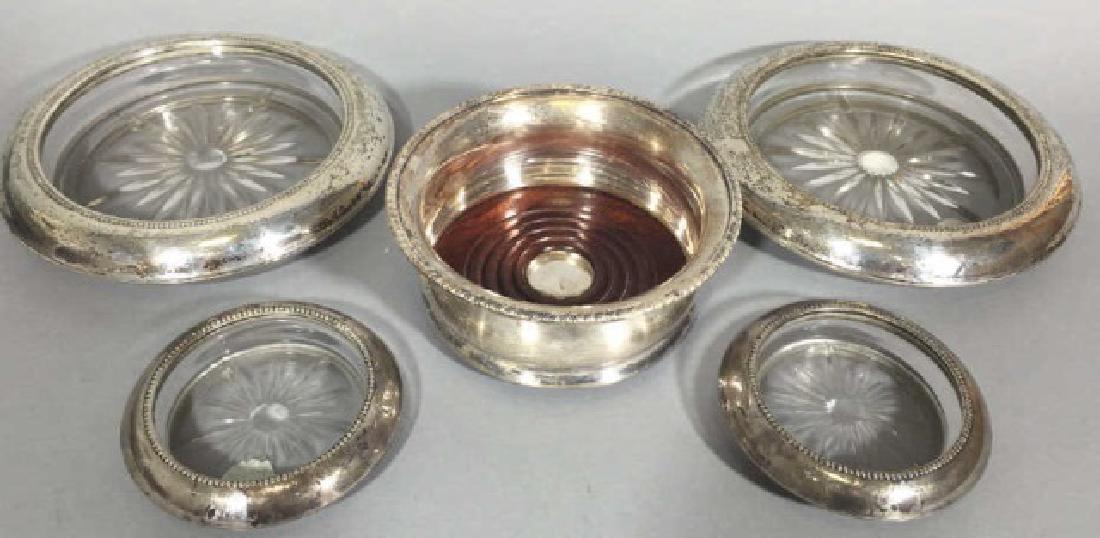 4 Sterling Silver & 1 Silver Plate Table Coasters: 4 Sterling Silver & 1 Silver Plate Table Coasters. All Sterling coasters are marked Sterling for Frank M. Whiting, while silver plate wine coaster is Reed & Barton. Larger pair of coasters measures 7