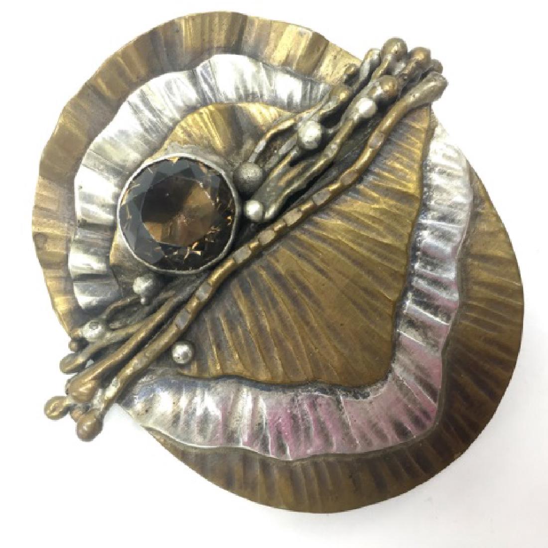 Vintage Handmade 70s Signed ELLIS Artisan Pin: Vintage Handmade 70s Signed ELLIS Artisan Pin â€“ Pin is mixed metal with likely silver and brass with a large smokey topaz / quartz stone. Pin is 2.25â€ x 2â€ and signed on the back with �