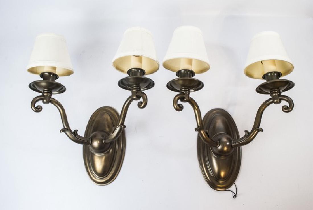 Pair of Bronze-Tone Double Light Metal Sconces: Pair of Bronze-Tone Double Light Metal Sconces with small shades. Having an oval backplate and curved scrolled arms. Measure 16 x 13 x 9 inches. From a designer decorated Connecticut home.