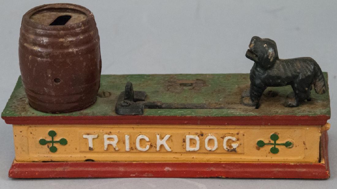 Vintage Cast Iron "Tick Dog" Bank: Vintage Cast Iron "Tick Dog" Bank, this trick dog bank was made in Taiwan, is intact in color and still functions, it is measured at 4.5 x 8 x 3 inches
